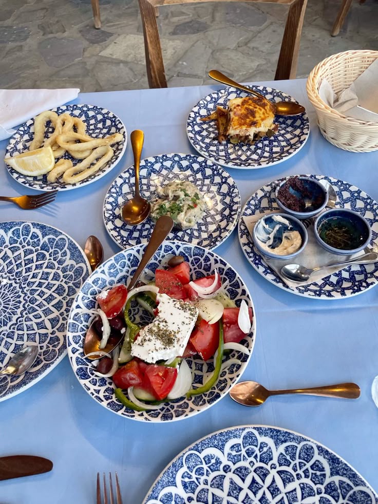 lunch at a beach club in mykonos with greek salad and mediterranean dishes