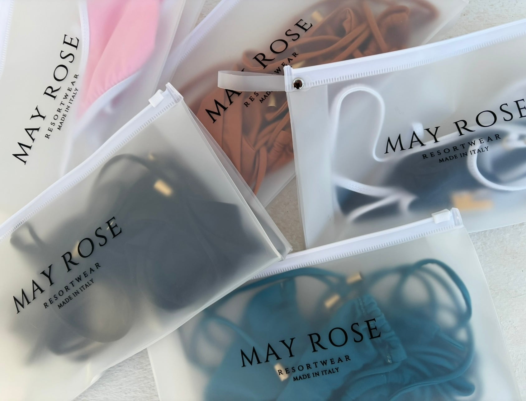 may rose swimwear pieces inside branded travel pouches